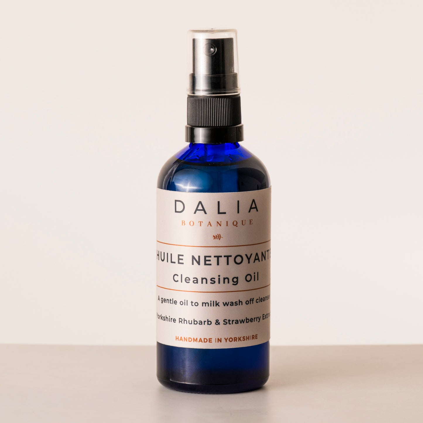 Bottle of Dalia Botanique cleansing oil on a light background