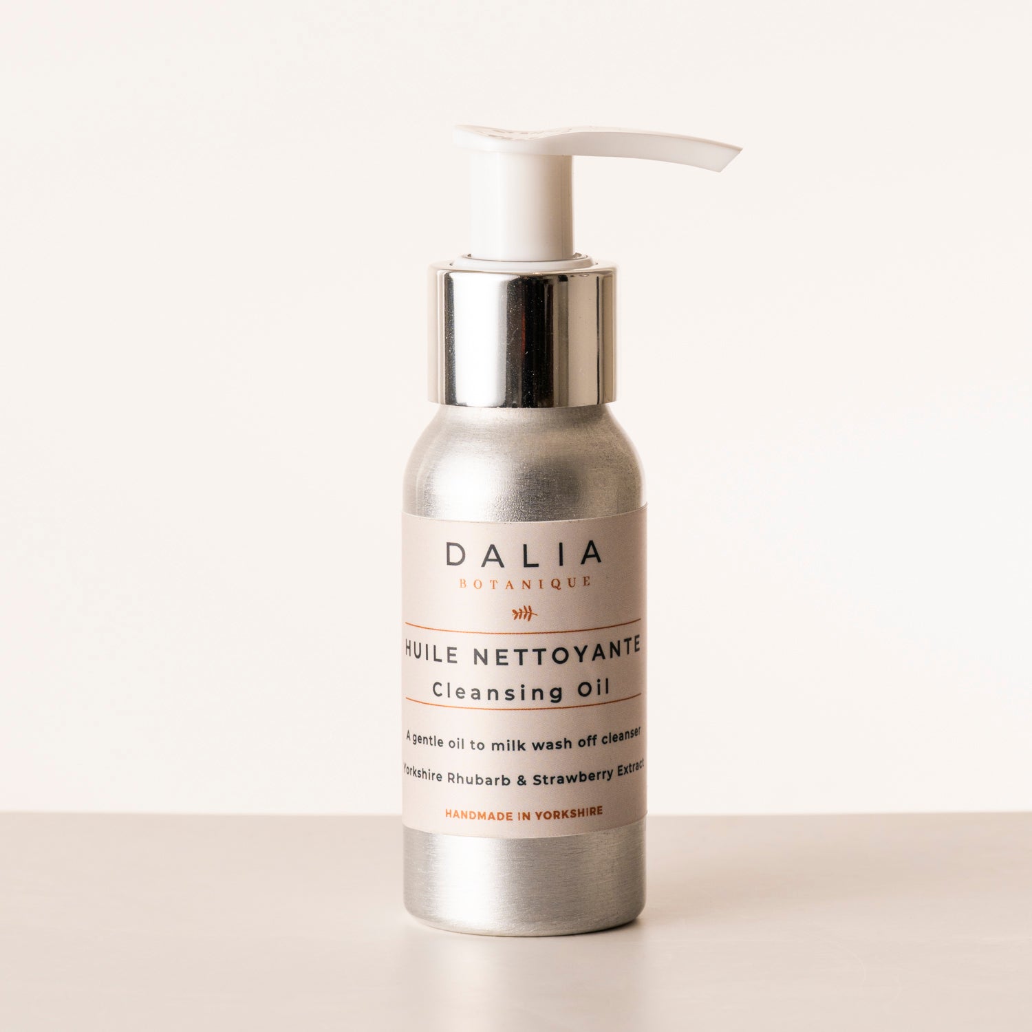 Silver bottle of Dalia Botanique cleansing oil on a white background